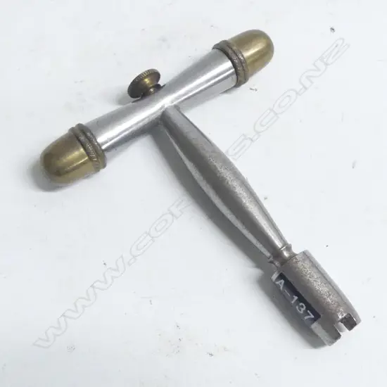 A nipple key by Peter Dyson, Yorkshire, England, steel with brass end caps.