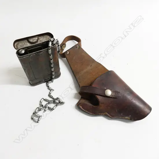 A vintage stitched leather pistol holster and a travelling gun cleaning kit