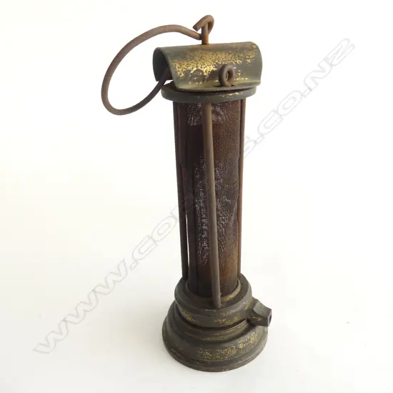 A miner's brass Safety Lamp, c.1900 Thomas & Williams style. The body being a long gauze section protected by three bars. H.235mm.