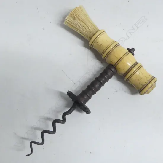 A Victorian period bone handled corkscrew with bristle brush and steel helix.