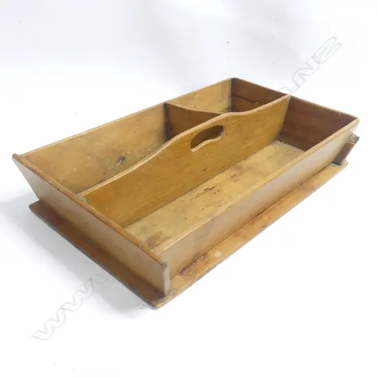 A NZ colonial Kauri three compartment cutlery tray with sloping sides and central handle. 450 x 290mm.