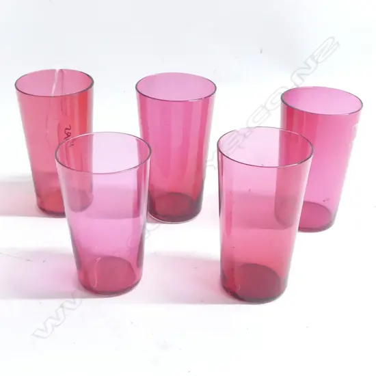 Five small cranberry glass beakers, H.95mm.