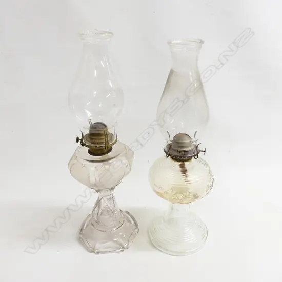 Two clear glass paraffin lamps