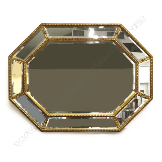 A decorative gilt framed wall mirror of octagonal shape