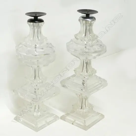 A pair of tall antique-style candle stands