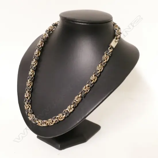 A heavy silver chain necklace