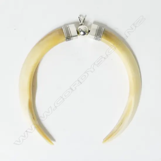 A contemporary large silver and tusk pendant