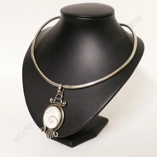 A silver and cats eye pendant