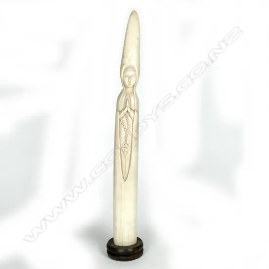 A tall slender African ivory tusk