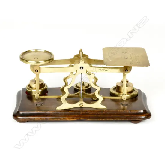 A set of brass postal scales on wood stand. Length 250