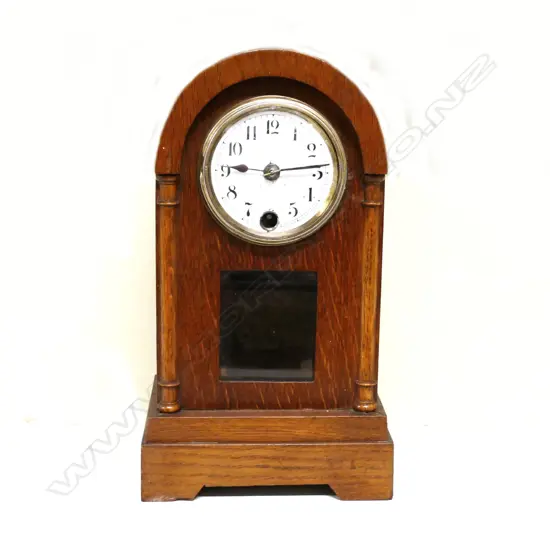 An oak cased mantel clock
