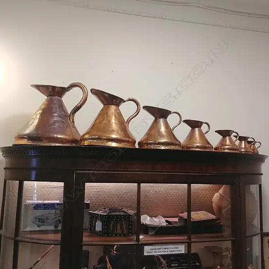 7 GRADUATED COPPER MEASURING JUGS