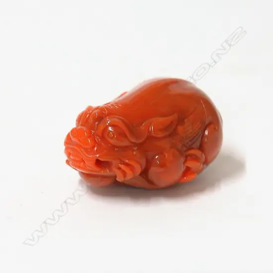 A Chinese red agate carved mythical animal