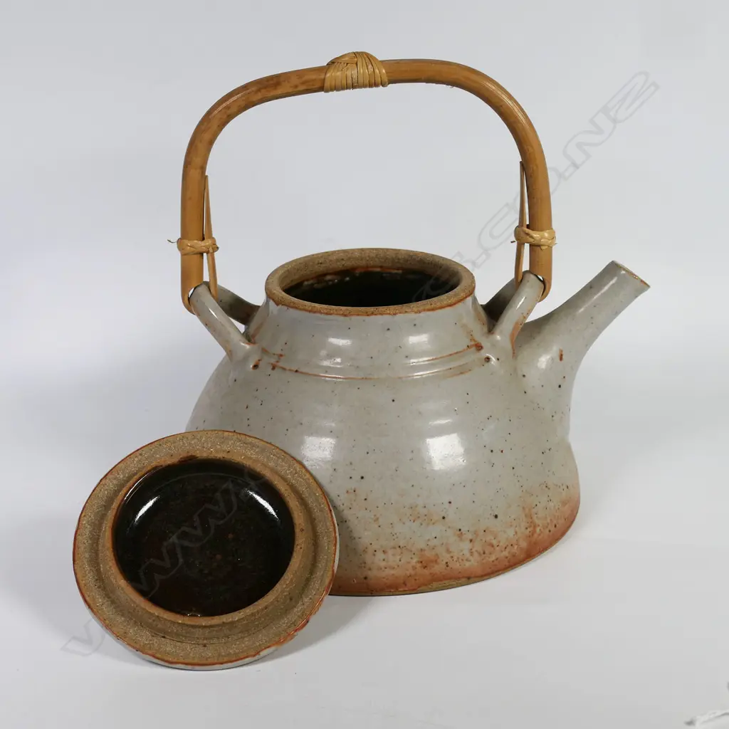 Peter Stichbury, Shino glazed tea pot with overhead bamboo handle, impressed potter's mark. H.220mm Dia.180mm. Image 1++