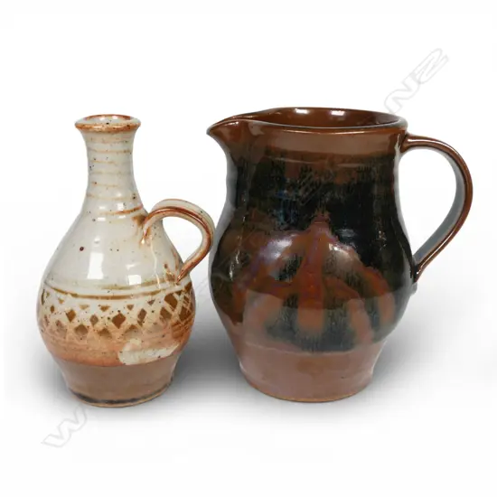 Peter Stichbury, one Shino wax resist decoration glazed jug and one tenmoku glazed jug H. 160mm both with potter's mark.