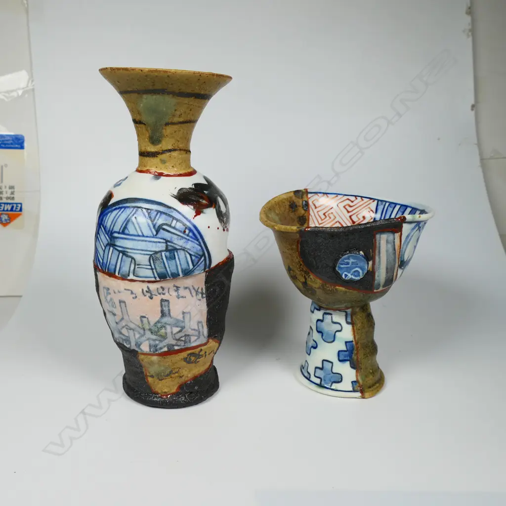 An Aaron Scythe yobitsugi style vase and goblet, distinct panelled sections of dark matte slips, and porcelain featuring bright blue and white overglaze decoration. H.170 & 105mm. Ex. Anneke Borren Collection. Image 1++