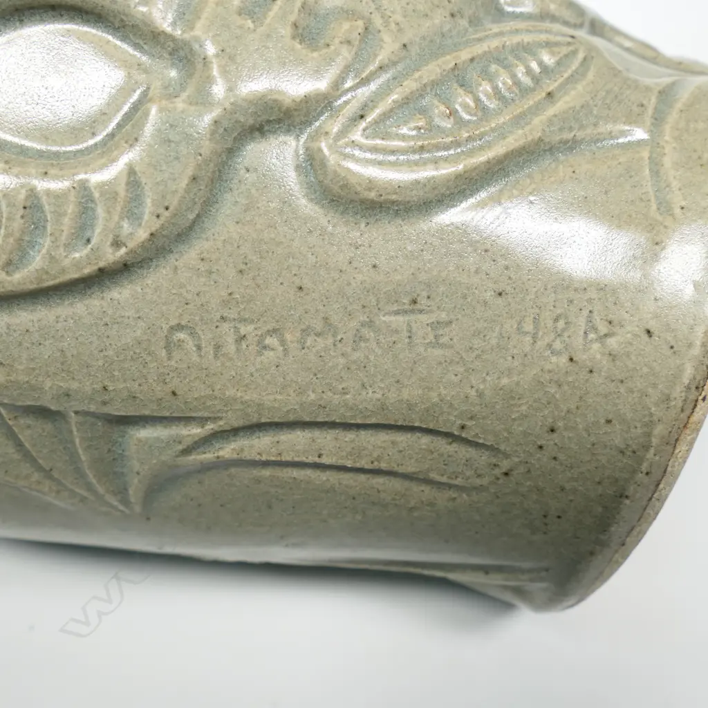 New Zealand studio pottery vase with sculpted Tiki in bas relief and inlaid paua eyes, indistinct insciption. H.300mm. Image 1++