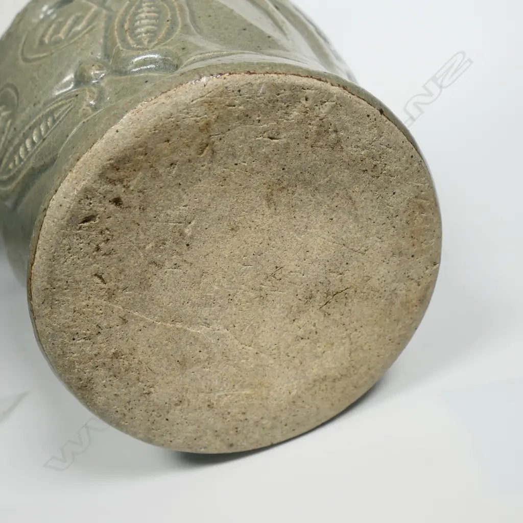 New Zealand studio pottery vase with sculpted Tiki in bas relief and inlaid paua eyes, indistinct insciption. H.300mm. Image 1++