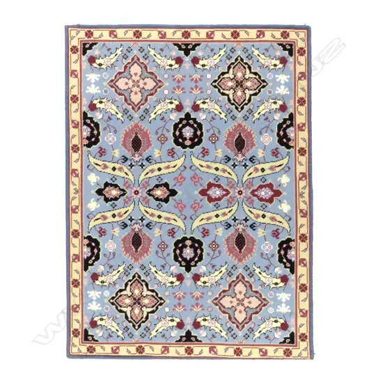 A hand embroidered panel depicting a Persian rug design