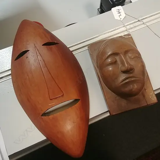 TWO CARVED WOODEN MASK ORNAMENTS 