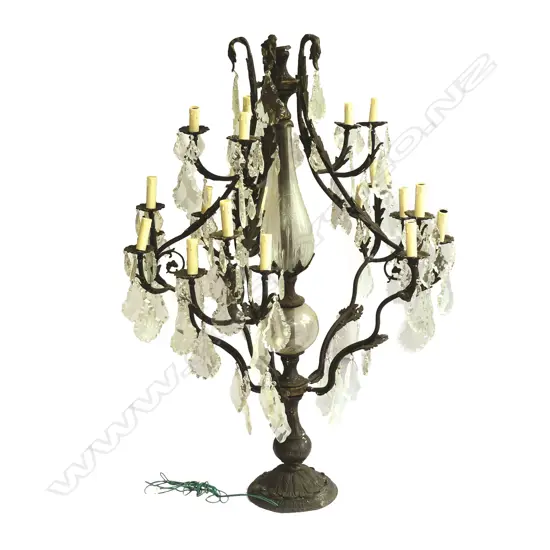 An impressive wrought iron and crystal floor standing chandelier