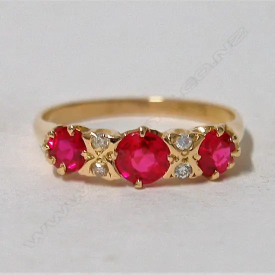 An 18ct. yellow gold estate diamond and synthetic ruby ring