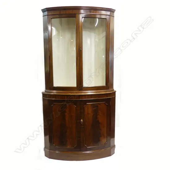 A George III style 20thC flame mahogany standing corner cabinet