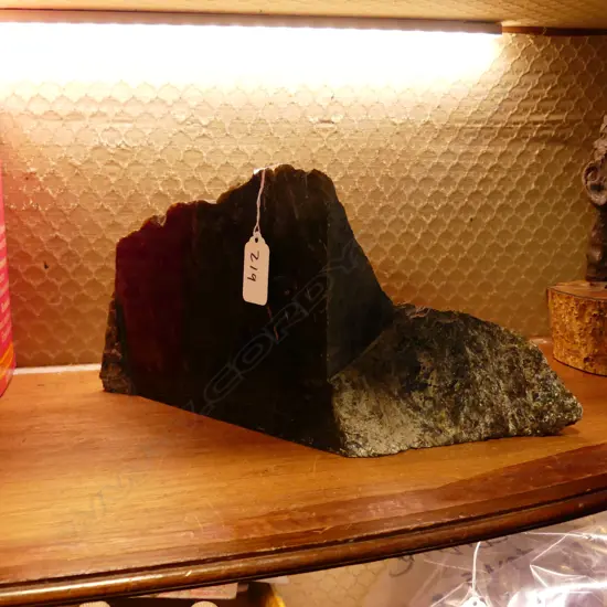 A natural and polished piece of pounamu