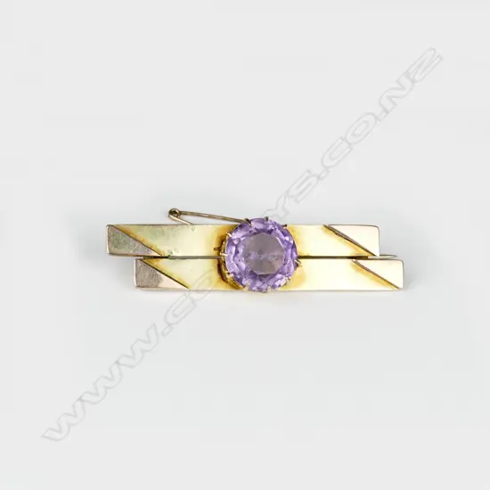 A 9ct. gold and amethyst bar brooch