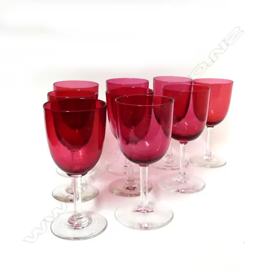 A set of nine cranberry glass stemmed port wine glasses