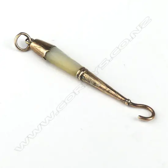 A 15ct. rose gold mother-of-pearl boot-hook pendant