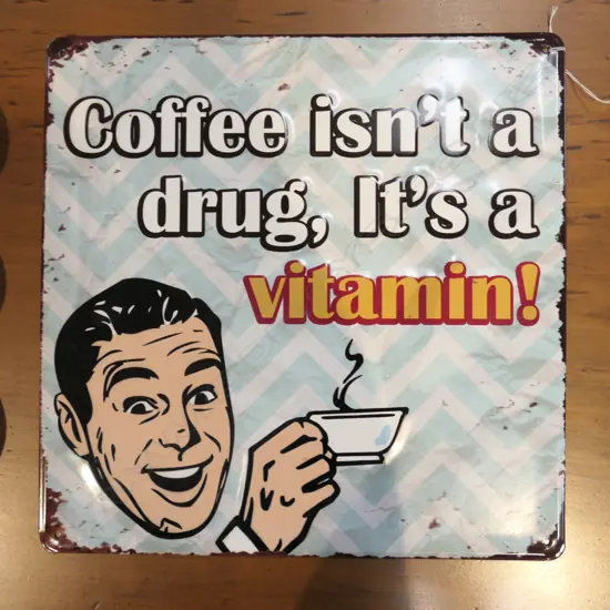 OLD STYLE TIN SIGN 'COFFEE ISN'T A DRUG IT'S A VITAMIN