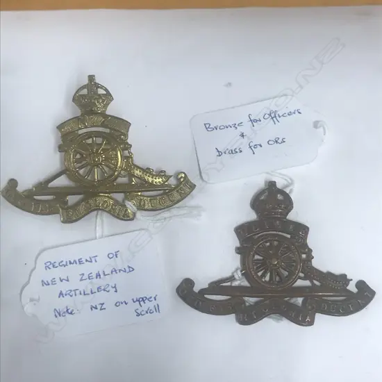 2 CAP BADGES: REGT OF NZ ARTILLERY [NZ in TS. KC. gilt]; ROYAL REGT OF NZ ARTILLERY (2)