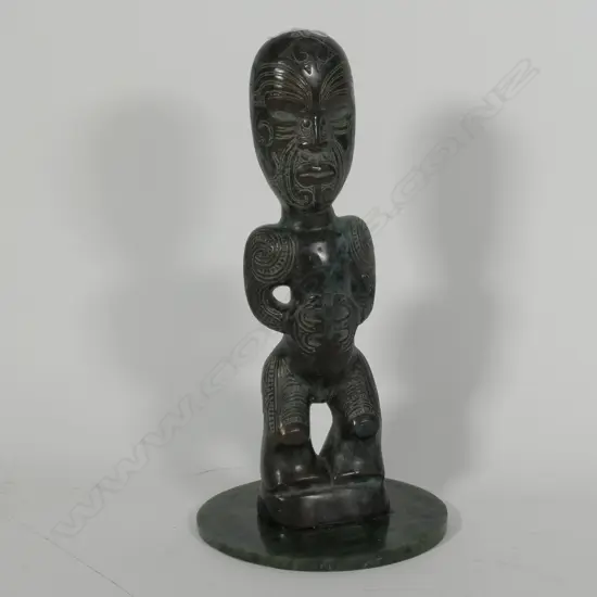 CAST BRONZE MAORI TEKOTEKO FIGURE ON A CIRCULAR POUNAMU BASE H 380 MM