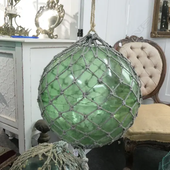 OLD LARGE GLASS FISHING FLOAT WITH NETTING...