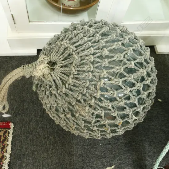 OLD LARGE GLASS FISHING FLOAT WITH NETTING...