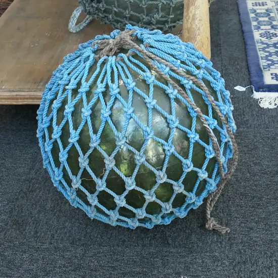 OLD LARGE GLASS FISHING FLOAT WITH NETTING...
