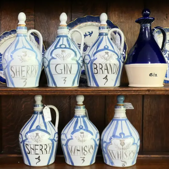 7 BUCHAN STONEWARE PORTOBELLO SCOTLAND FLASKS; 2X SHERRY, 2X WHISKY, BRANDY, GIN AND ONE OTHER (GIN) 