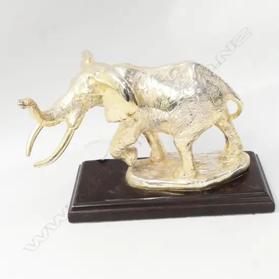 SILVER ELEPHANT ON WOODEN MOUNT - STAMPED D.G STERLING SILVER W. 200MM