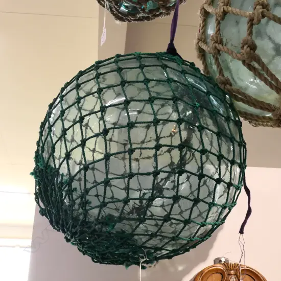 OLD GLASS FISHING FLOAT WITH NETTING...