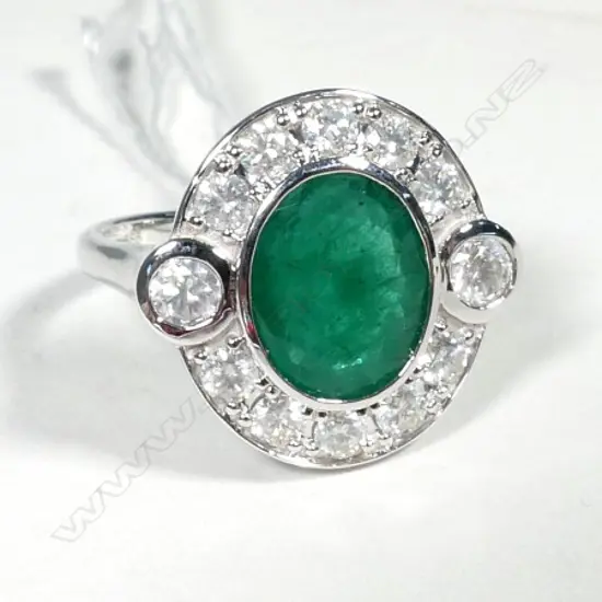 14ct White Gold Emerald and Diamond halo ring featuring centre