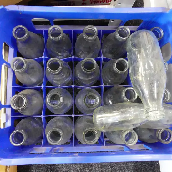 PLASTIC MILK CRATE FULL WITH OLD MILK BOTTLES