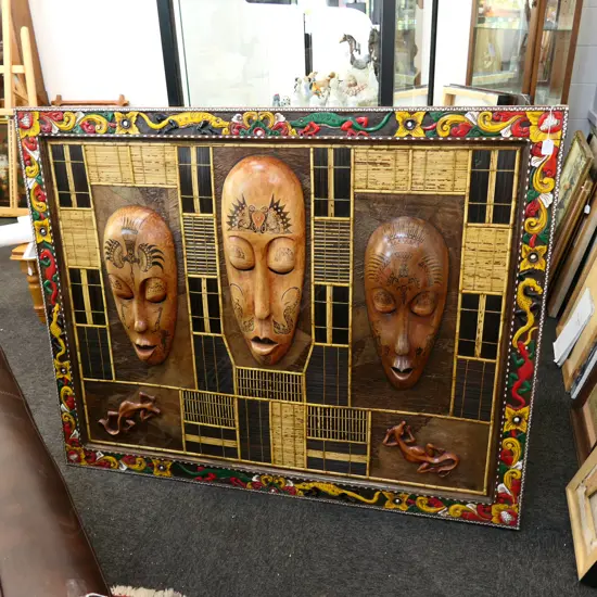 LARGE FRAMED LOMBOK 3 CARVED HEADS W.1147MM X 1180MM FADED 