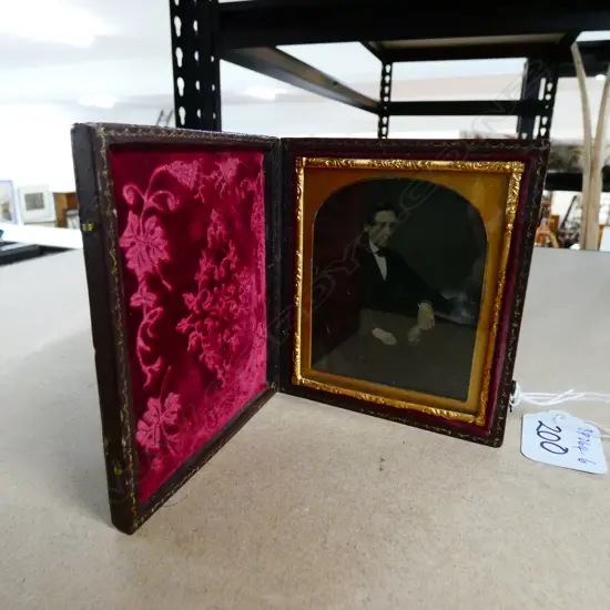 AMBROTYPE PORTRAIT OF A YOUNG MAN IN RED MOROCO CASE