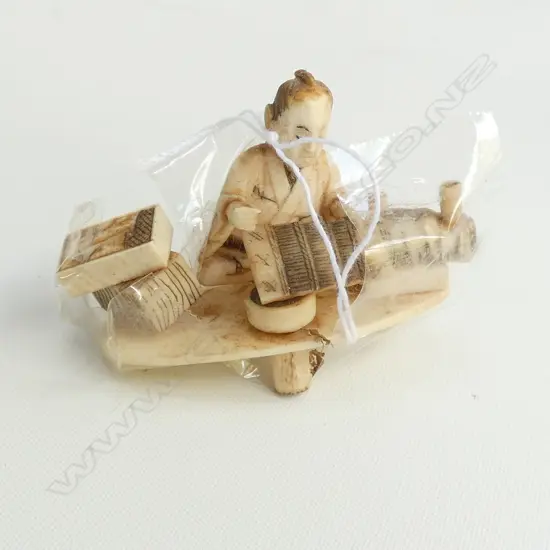 JAPANESE CARVED IVORY SEATED MAN