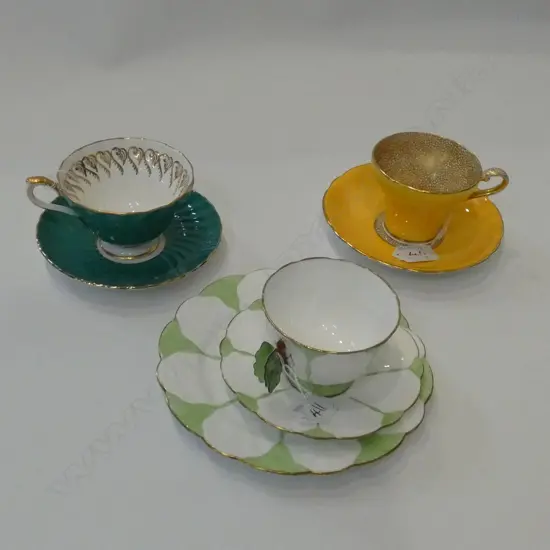 THREE AYNSLEY BONE CHINA CUPS & SAUCERS/TRIOS, GREENS & YELLOW