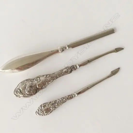THREE SILVER HANDLED MANICURE PIECES