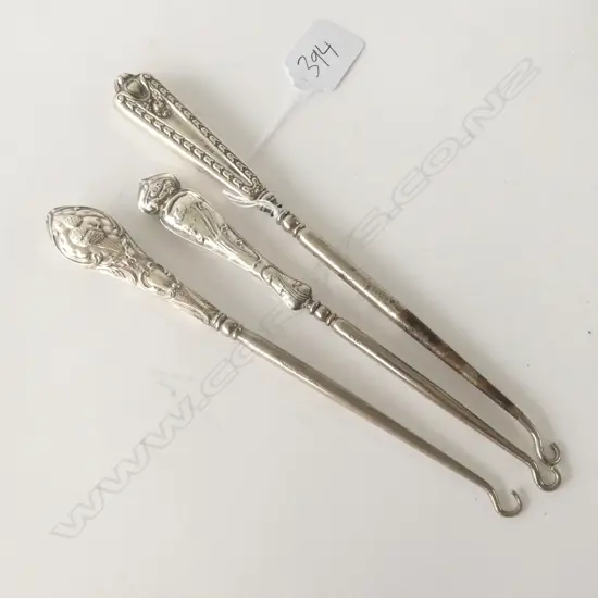 THREE SILVER HANDLED BUTTON HOOKS