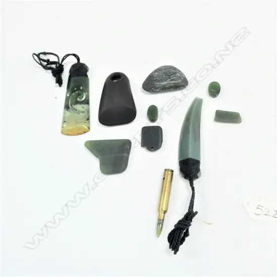 BAG OF GREENSTONE AND A BLACK STONE ADZE WITH LARGE HOLE