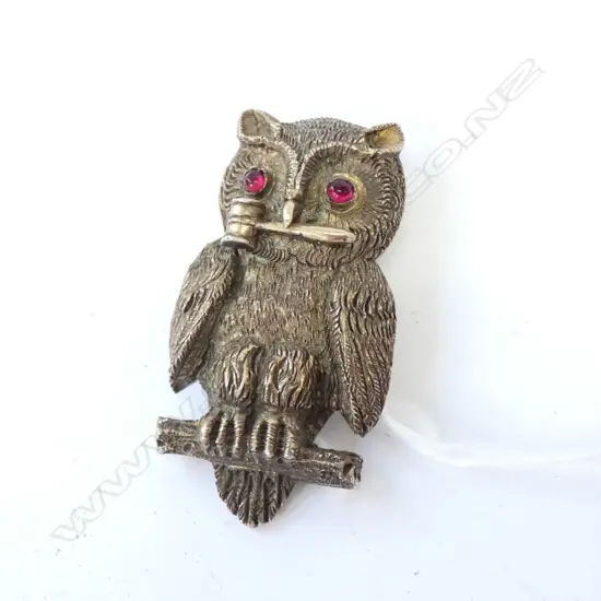 '1897 OWL CLUB' PRESENTATION S/PLATE OWL BUTTON HOLE BADGE. Slid cast and of good size fine detail red stone eyes. The owl with gavel to its mouth. The back engraved 'PRESENTED TO THE OWL CLUB BY J.A.BIRTS 1897'. With button hole fitting. H.52mm. Note: The Owl Club was founded in 1896 by Reginald Mansfield Johnson